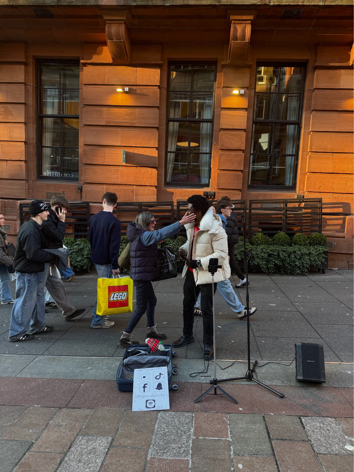 Francis Bondd meets a passer-by during a street performance in Glasgow. Photograph: Supplied