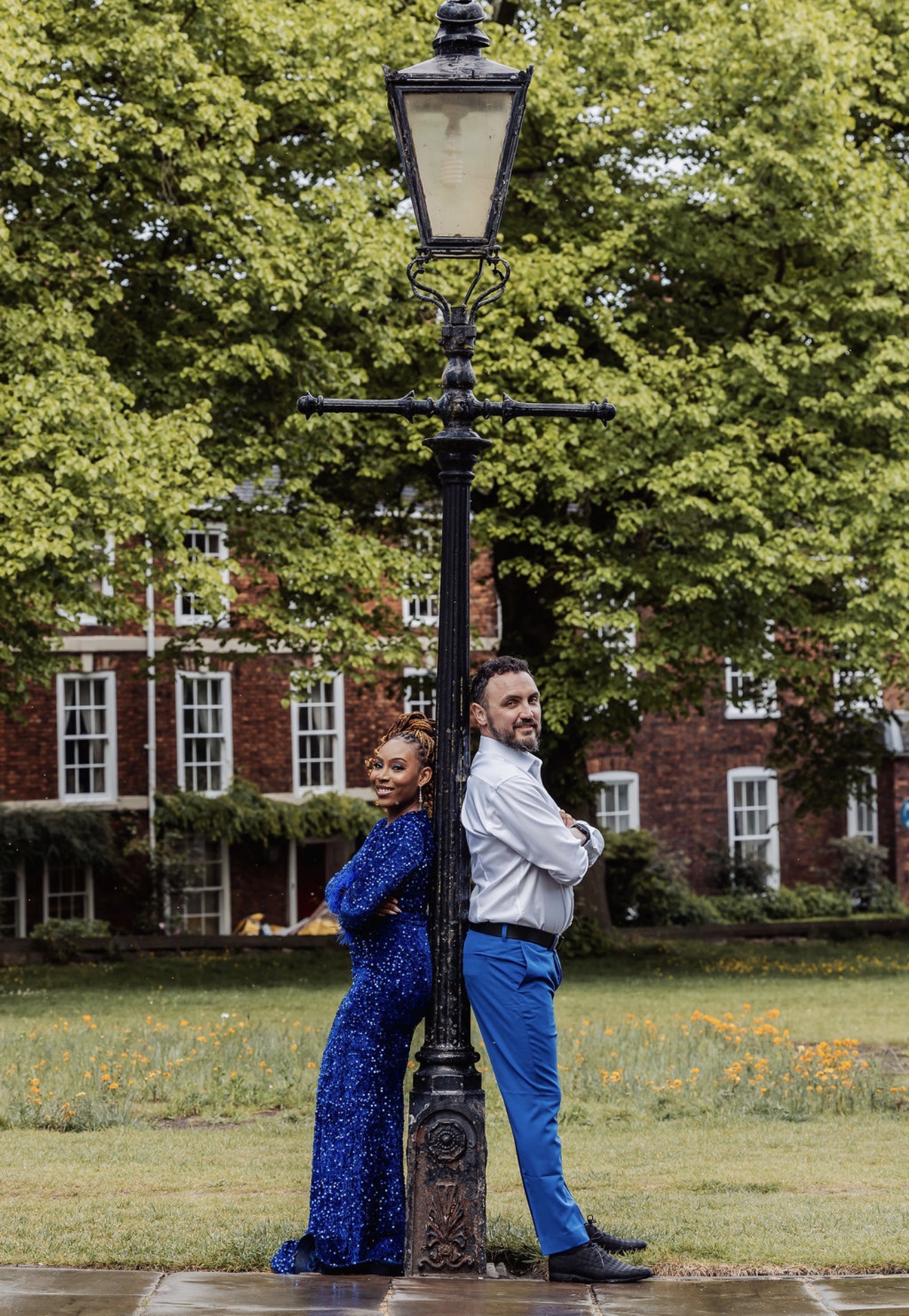 Gabriella and Elliott pose back to back beside a traditional lamppost. Photograph: Thomasxphotography