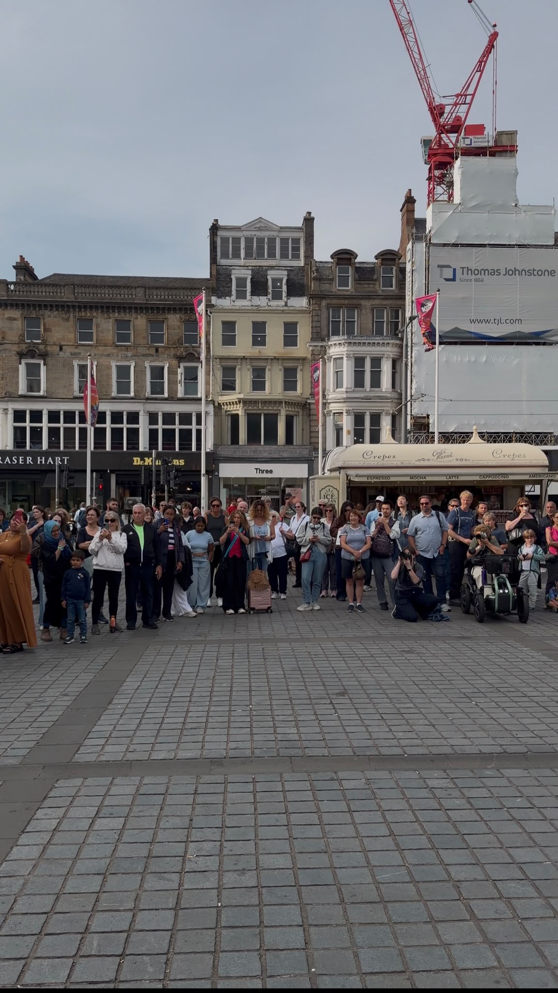 Spectators gather along the street for the Edinburgh Fringe Festival performance. Photograph: Supplied